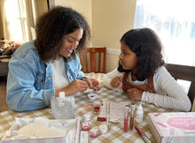 Family members using a Deluxe DIY Kit Creations Lip Gloss Kit together