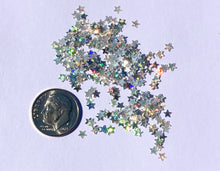 view of biodegradable wishing star glitter next to US dime for size reference 